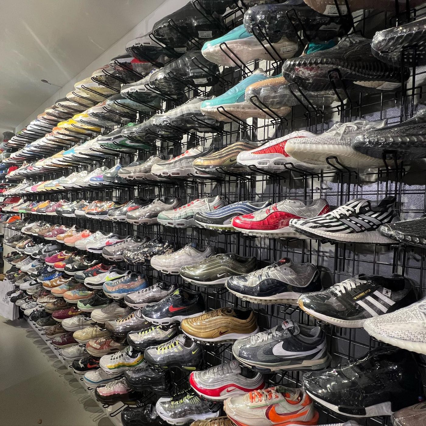 Dense wall of sneakers on display