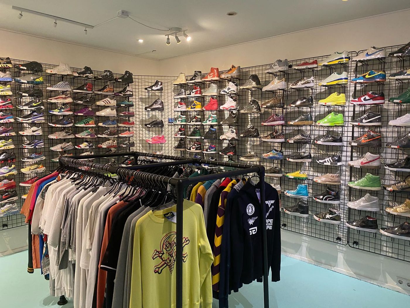 Store interior with sneaker walls and clothing racks